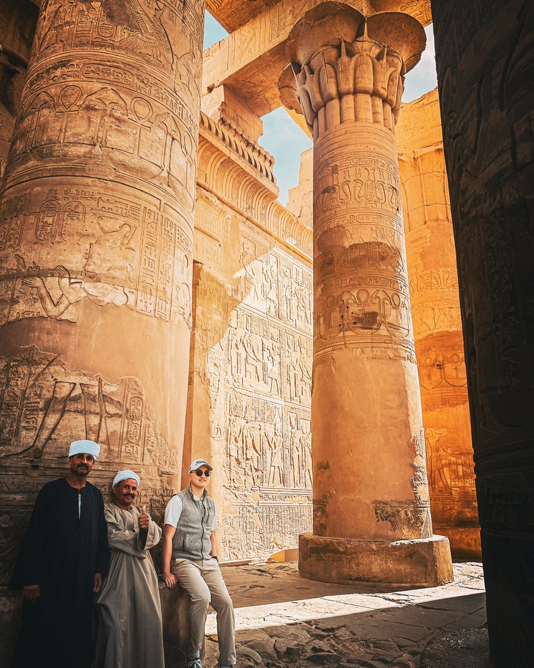 Johnew with two local men among the carved columns of Edfu's hypostyle hall
