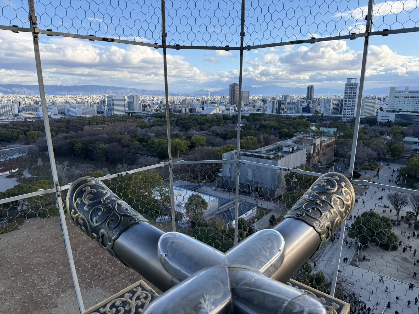 The view over Osaka from the castle's top floor, framed by ornamental roof ends