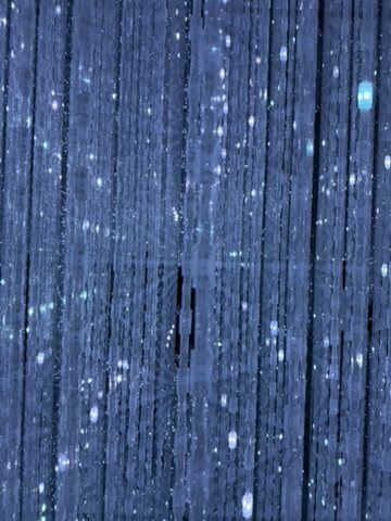 Strings of tiny lights in a dark room