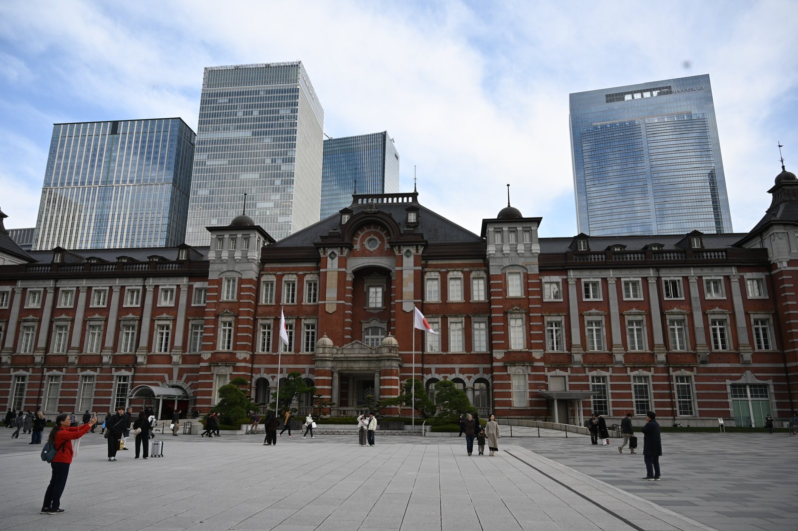 The red-brick Marunouchi building of Tokyo Station, with glass towers behind it