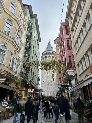 A crowded street leading up to Galata Tower
